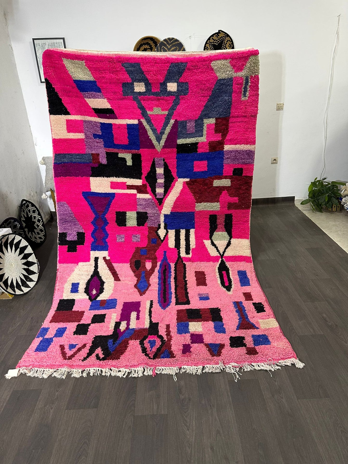 Colorful geometric-patterned rug on a wooden floor