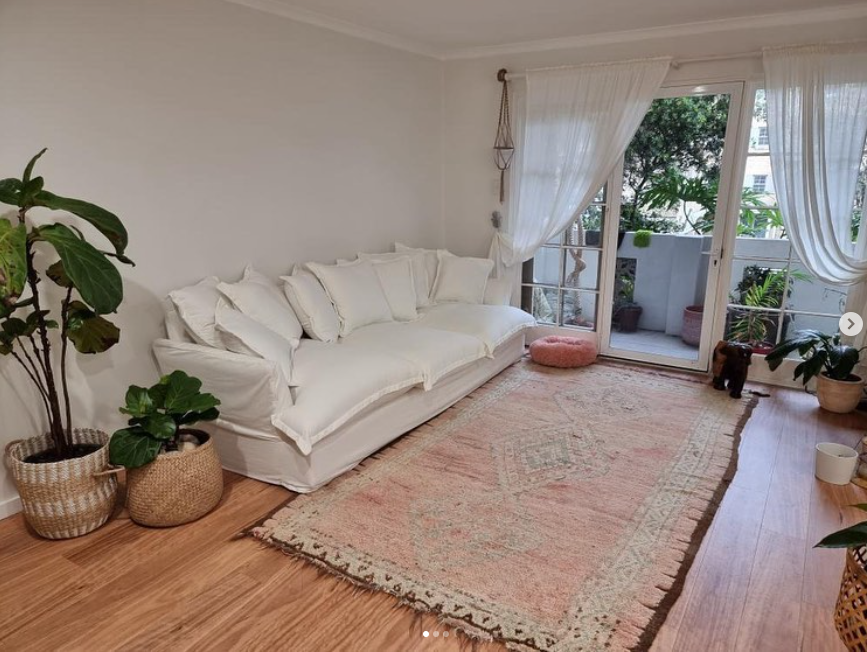vintage rug in home with white walls, lounge and plants. 