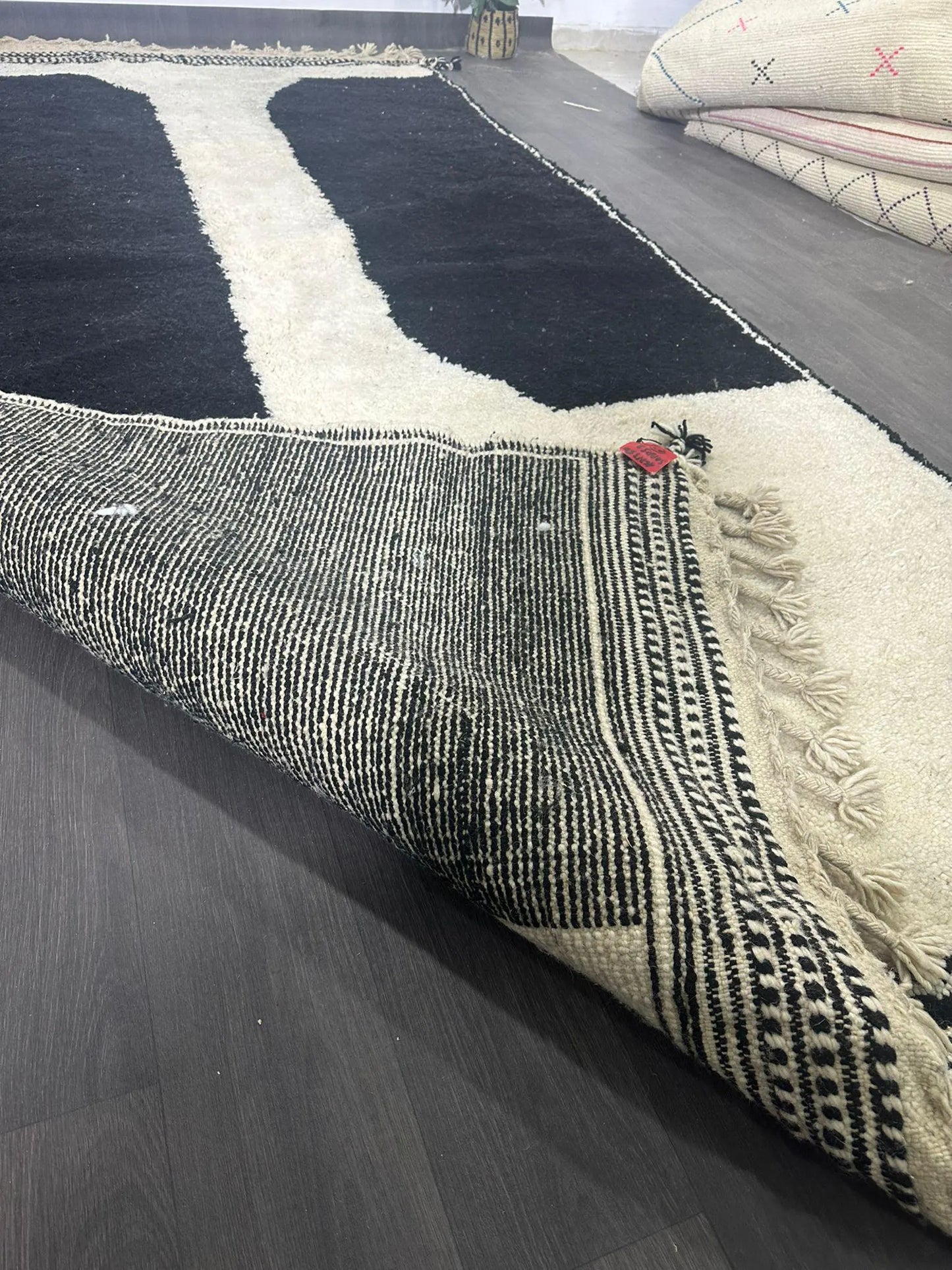 Textured area rug with geometric pattern on a dark wooden floor