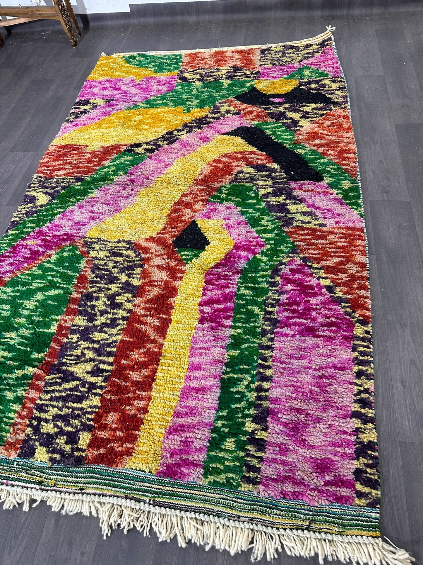 Colorful abstract rug on a dark floor