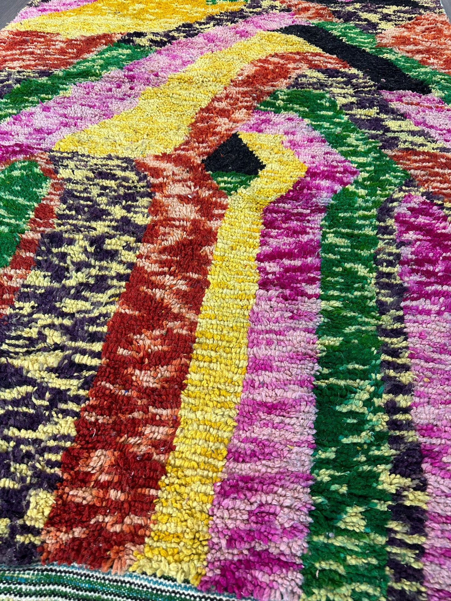 Multicolored textured fabric with a pattern of wavy lines.