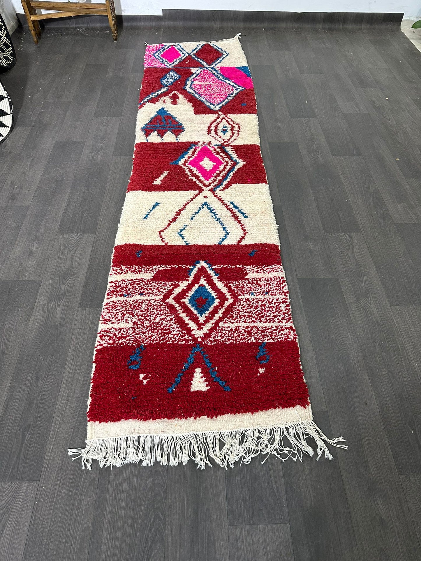 Decorative rug with geometric pattern on a wooden floor