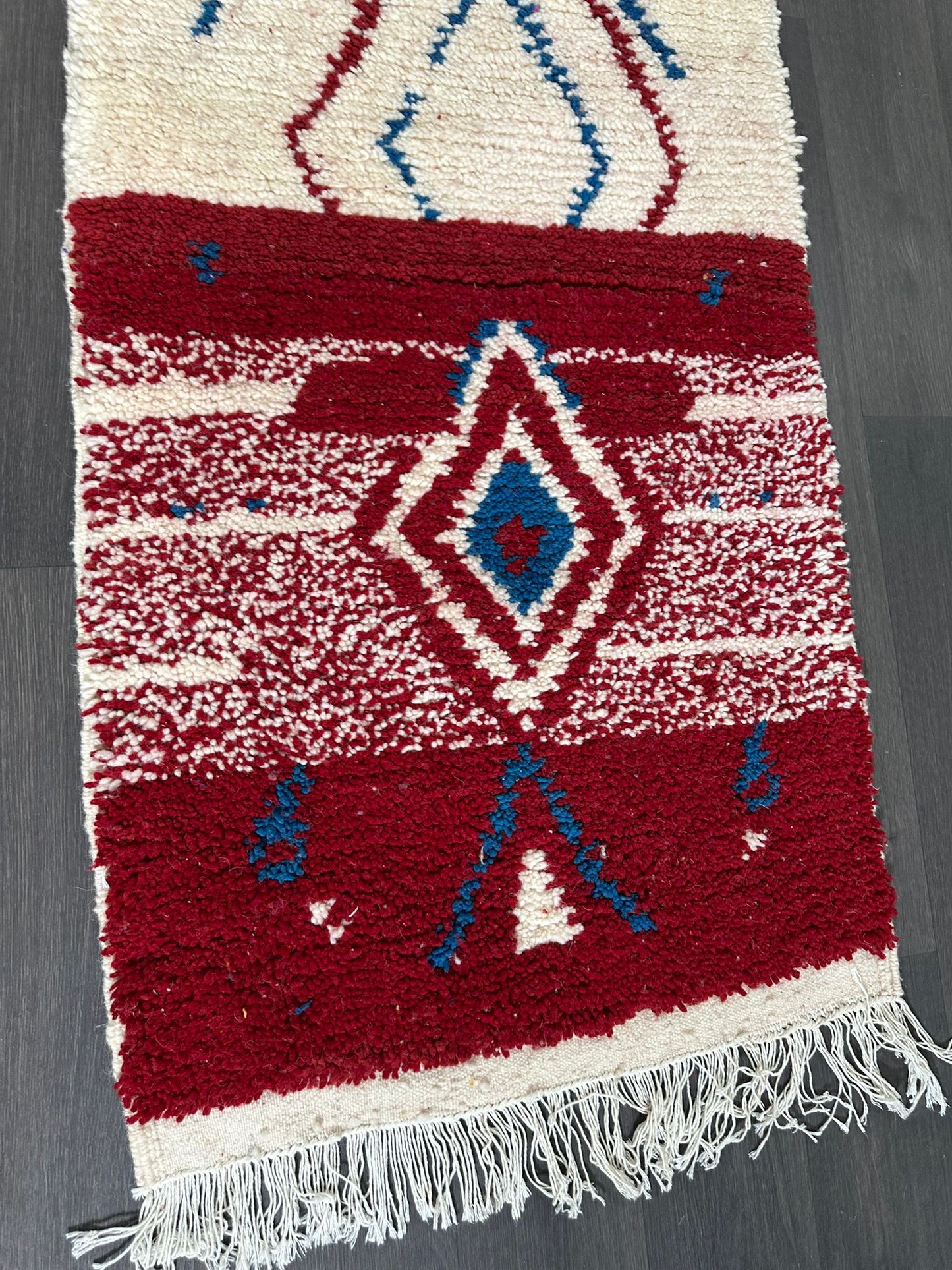 Woven rug with geometric pattern on a plain background