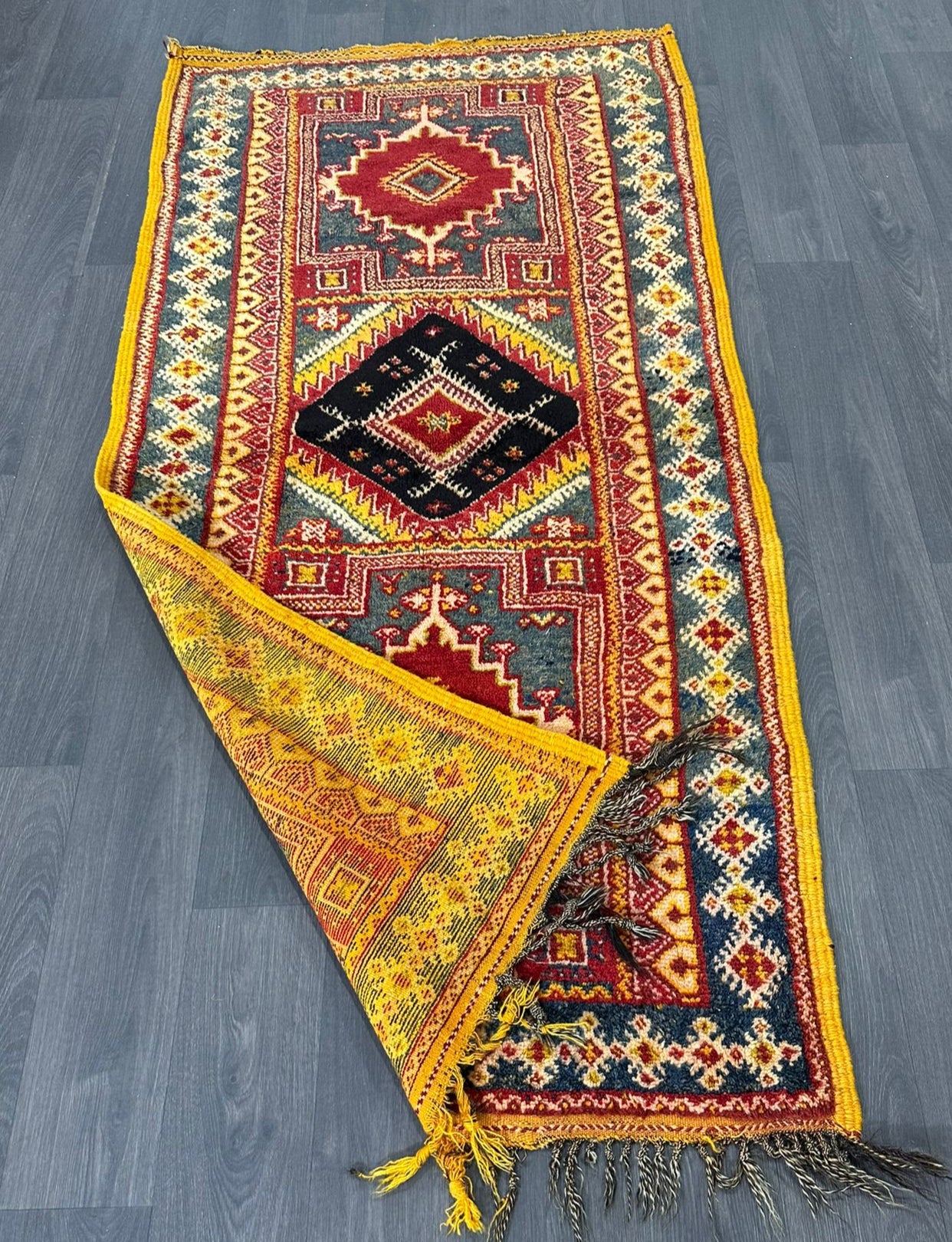 Vintage moroccan rug with geometric pattern on a wooden floor
