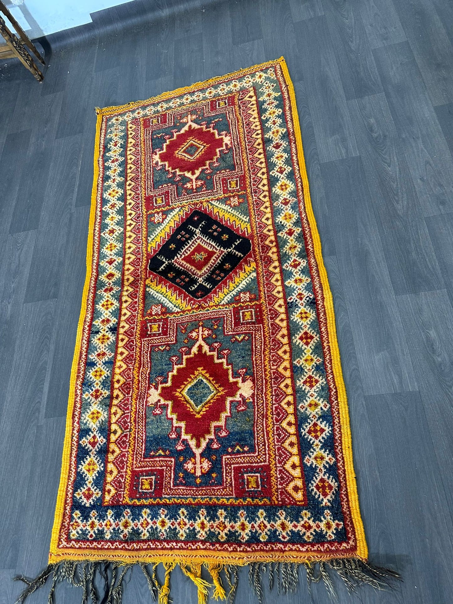 Vintage moroccan rug with geometric pattern on a wooden floor