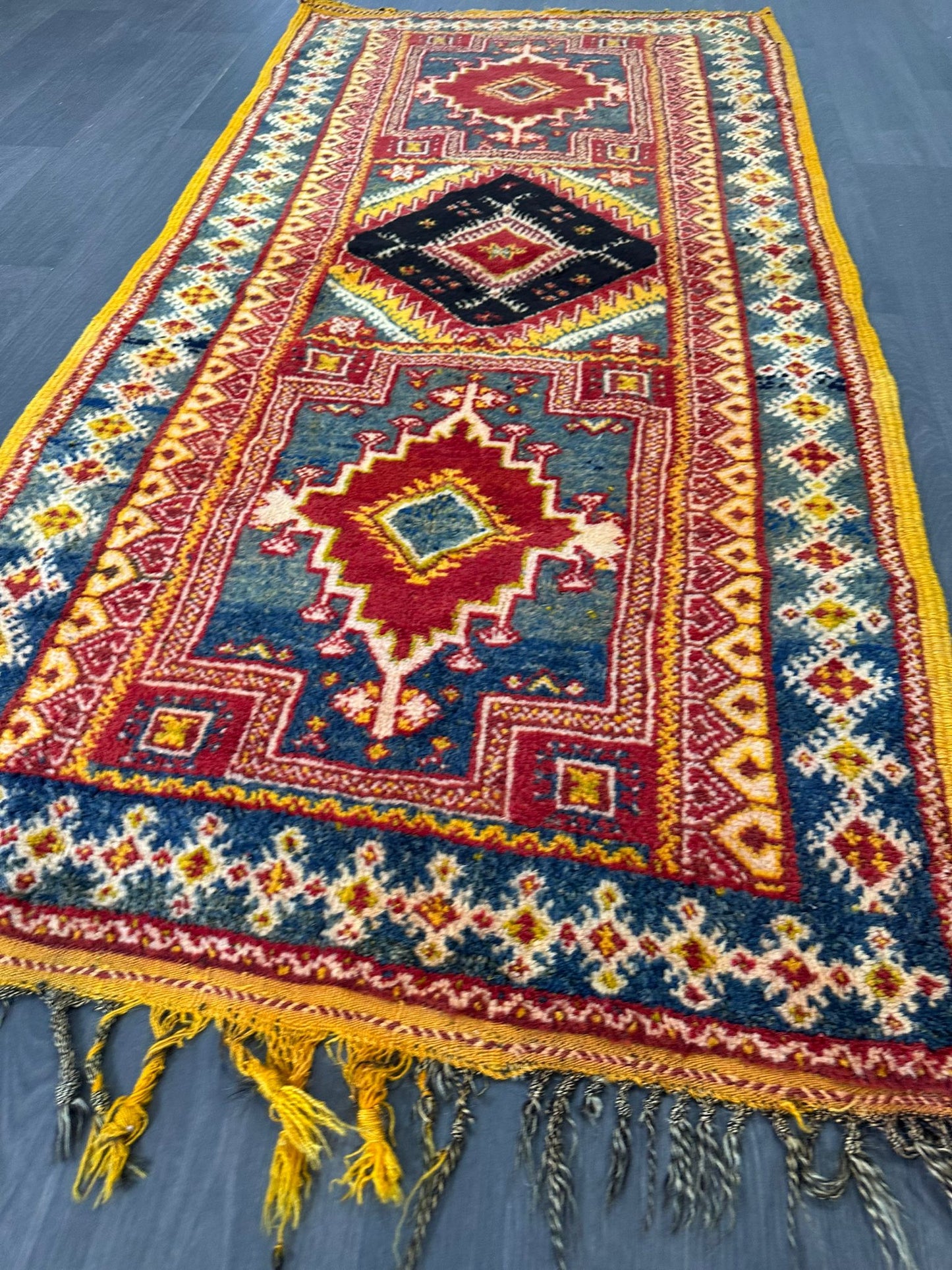 Vintage moroccan rug with geometric pattern on a wooden floor