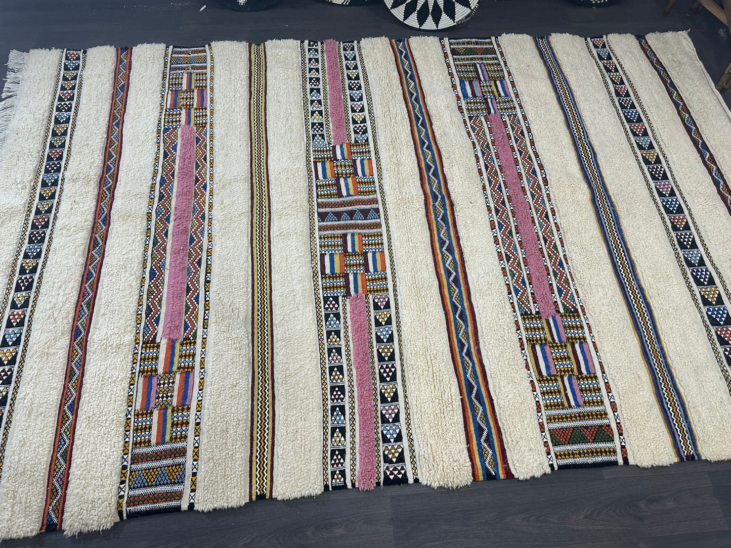 Collection of woven strips with geometric patterns on a dark surface
