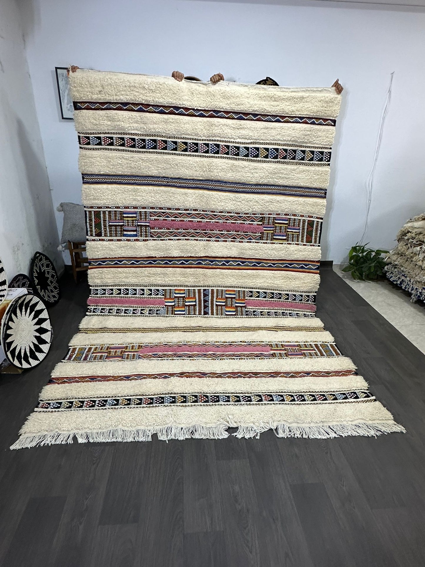 Woven rug with geometric pattern on a wooden floor