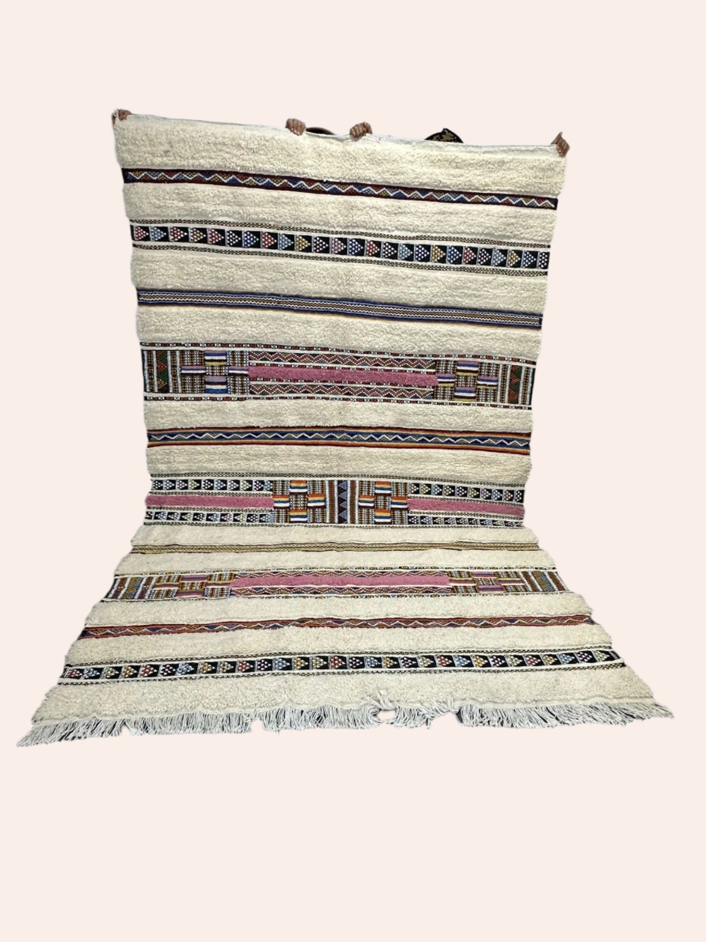 Woven rug with geometric pattern on a wooden floor