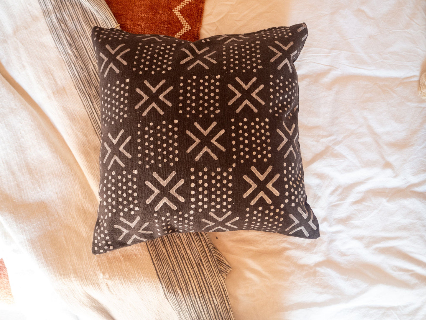 top view of mudcloth cushion with spots and crosses pattern
