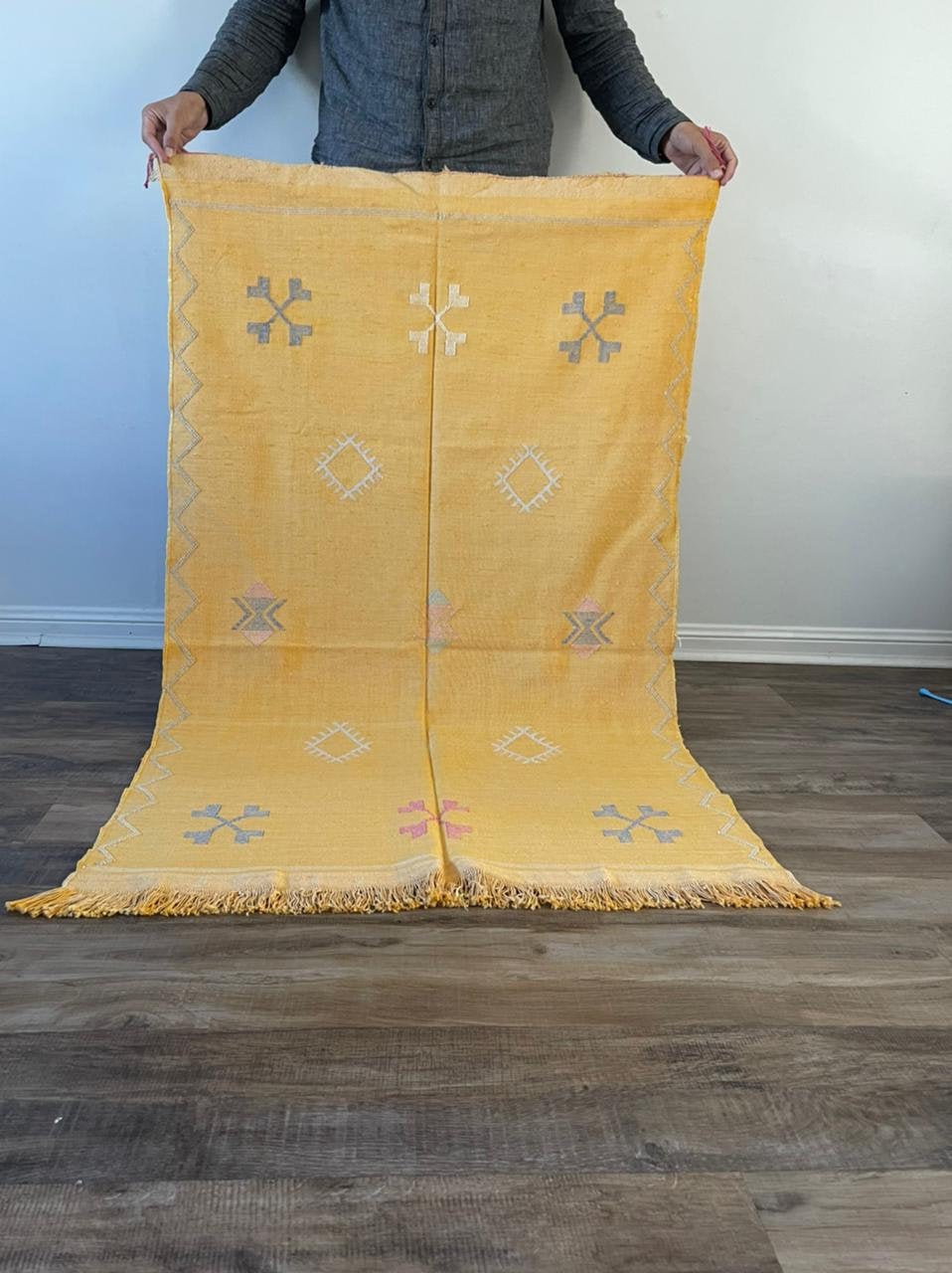 Yellow cactus silk rug with mutli coloured symbols woven into it