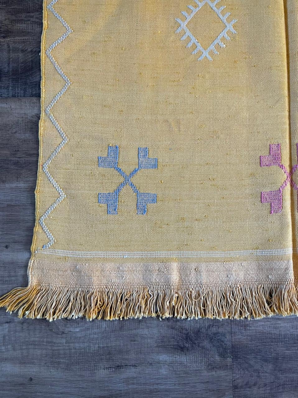 Yellow cactus silk rug with mutli coloured symbols woven into it