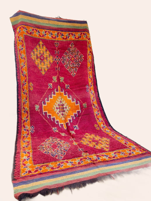 Vibrant red Moroccan Vintage rug with orange and blue/purple accents and symbols