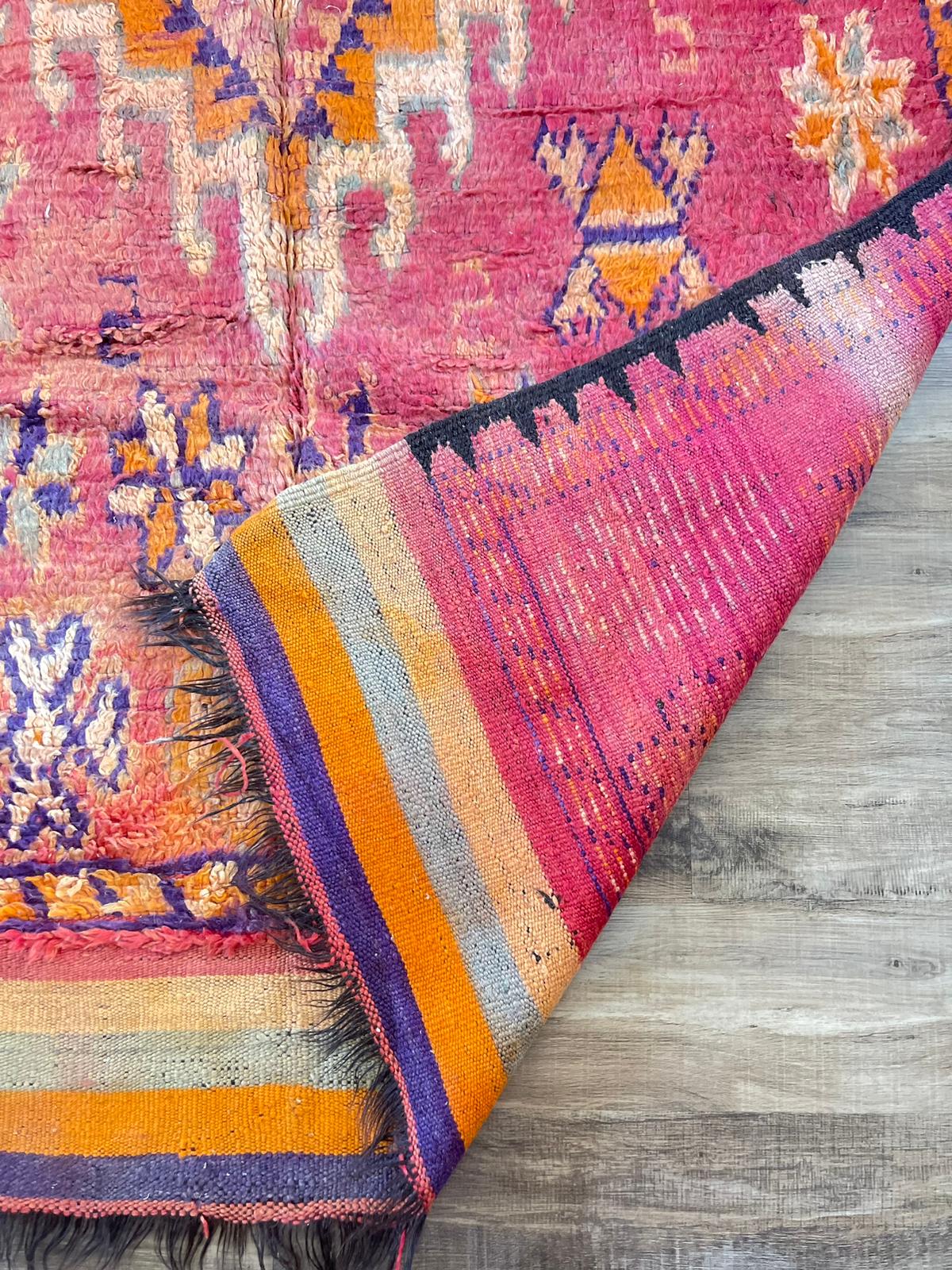 Warm vibrant red vintage Moroccan rug with orange and purple symbols