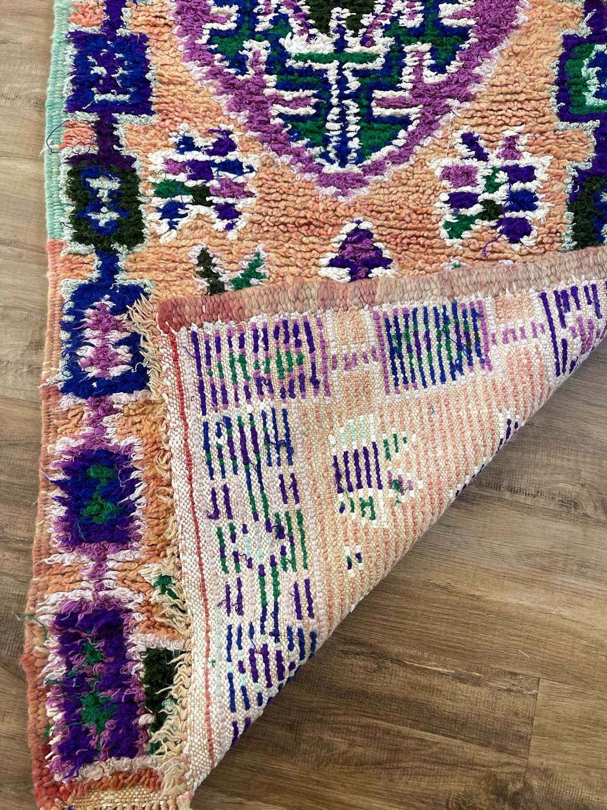 Vintage peach Moroccan runner with blue and purple tribal patterns and symbols