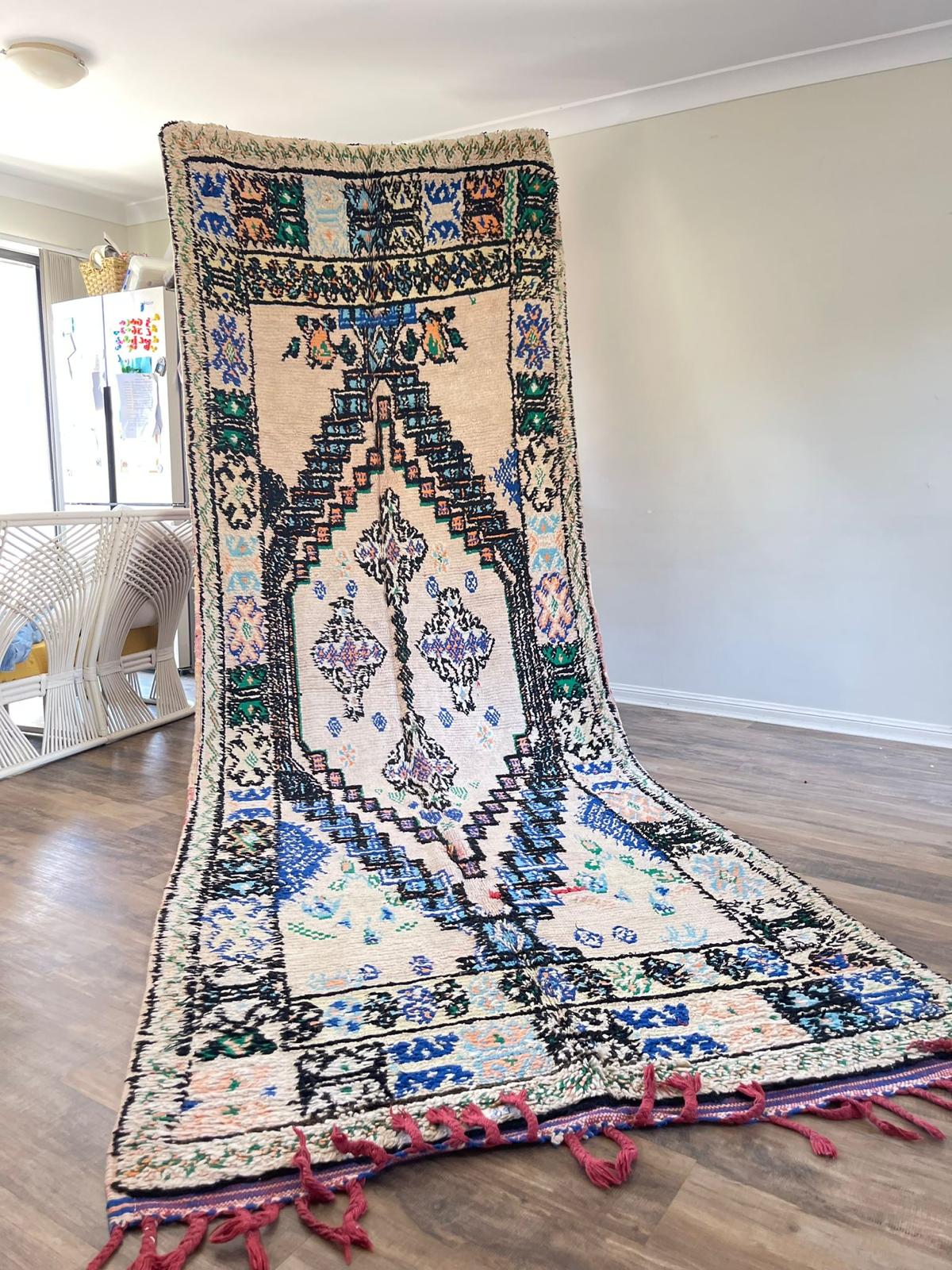 cream coloured Vintage Moroccan boujaad rug with blue, green and light orange symbols and patterns