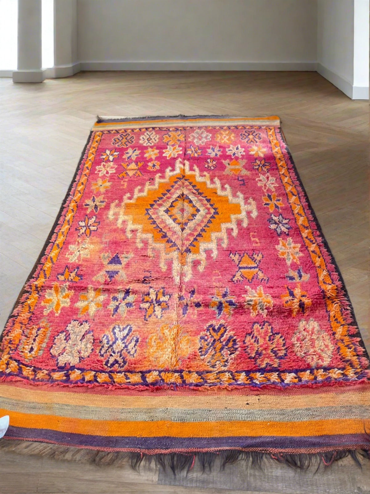 Warm vibrant red vintage Moroccan rug with orange and purple symbols