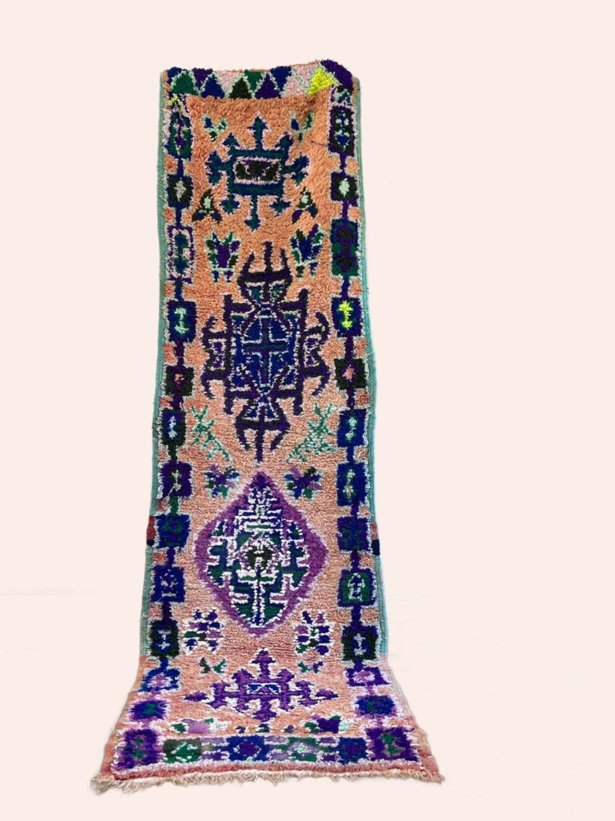 Vintage peach Moroccan runner with blue and purple tribal patterns and symbols 