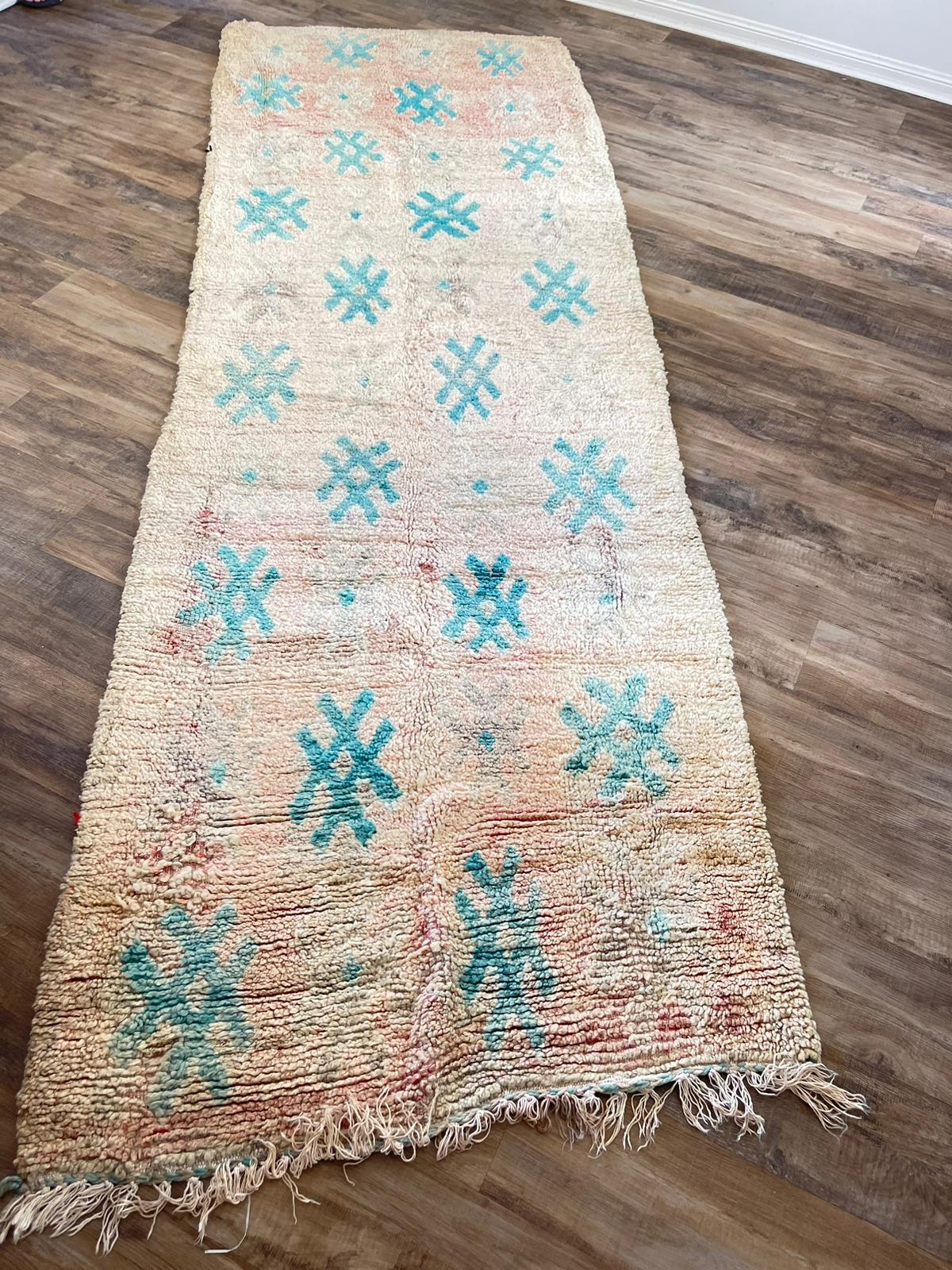 peach vintage Moroccan rug with blue symbols