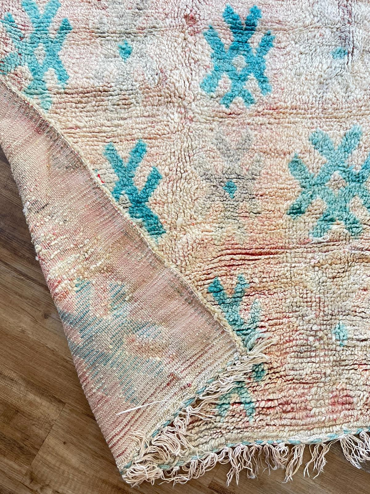 peach vintage Moroccan rug with blue symbols