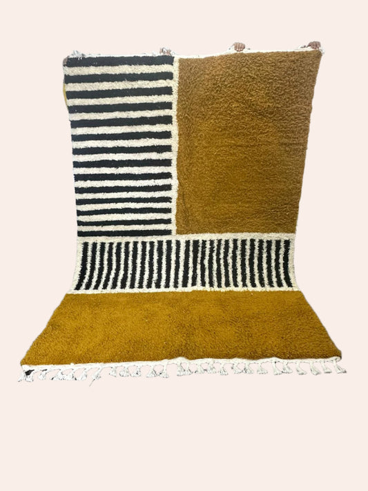 mustard rug with black and white stripes