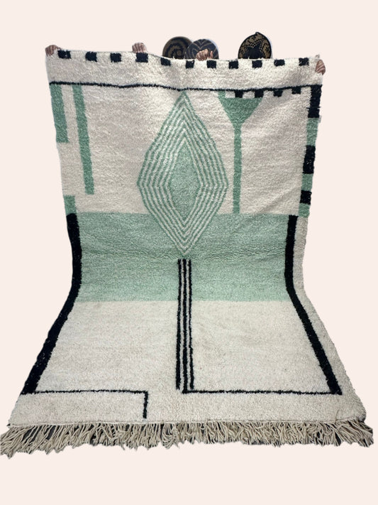 Eid is an off-white moroccan wool rug with light green and black design
