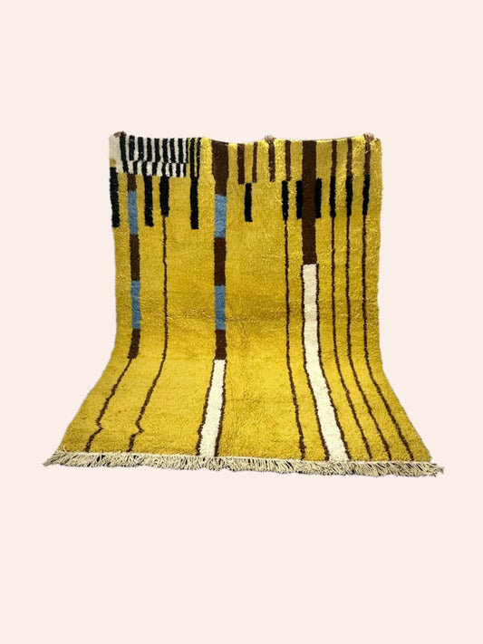 Hobous Moroccan wool rug is mustard coloured with dark brown, off white, black and light blue/grey striped