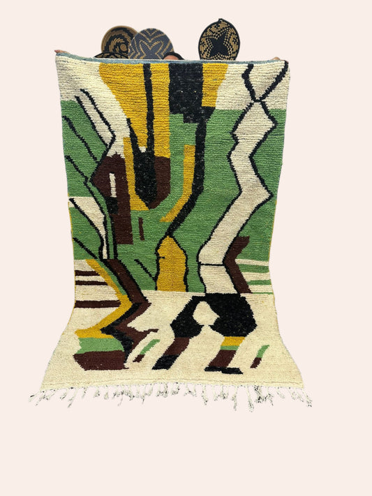 Colorful abstract Moroccan wool rug on a wooden floor with a white wall background