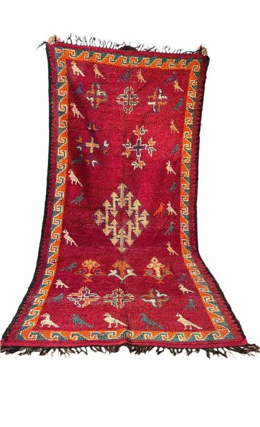 Vintage Moroccan rug being held up