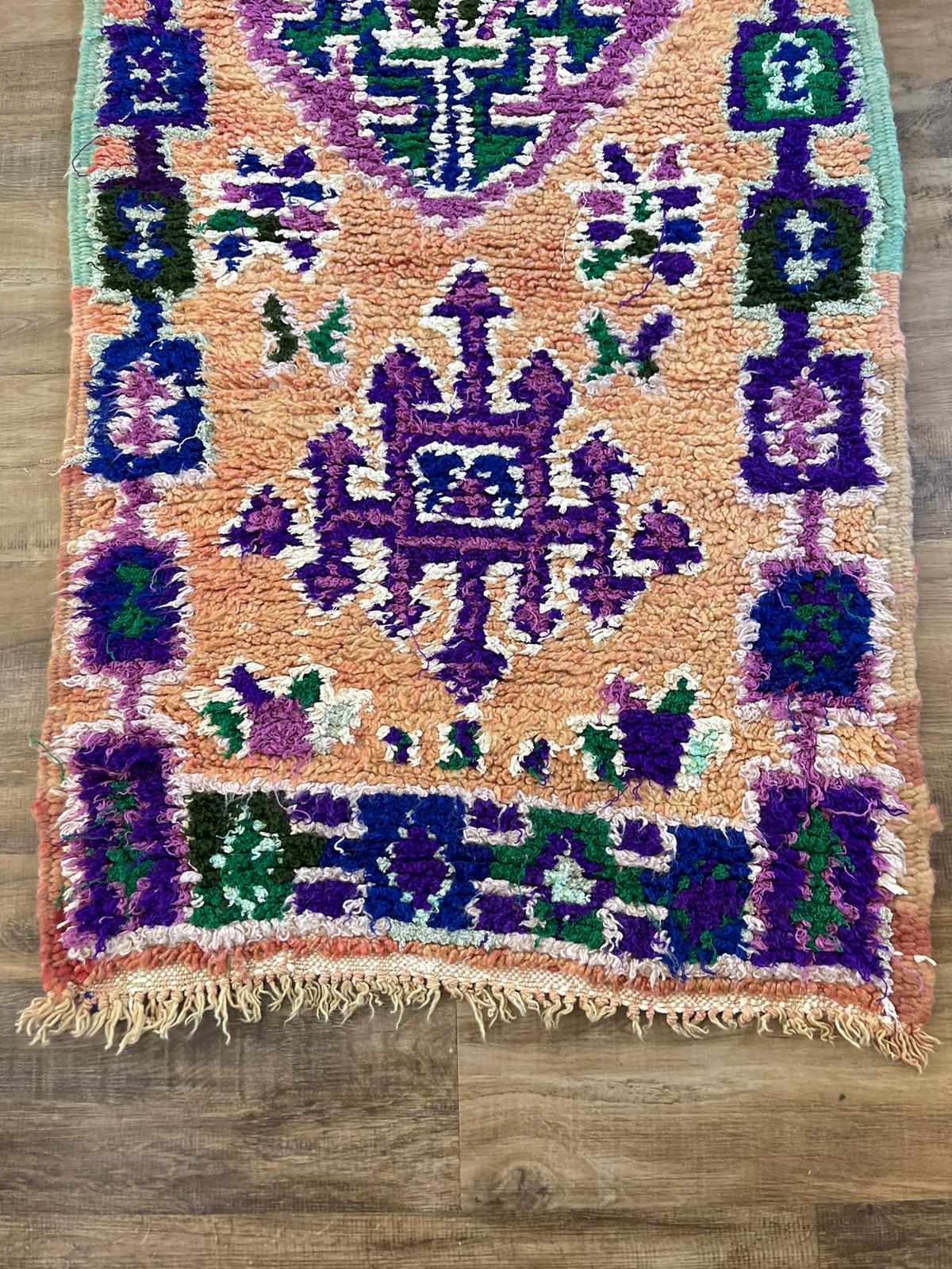 Vintage peach Moroccan runner with blue and purple tribal patterns and symbols