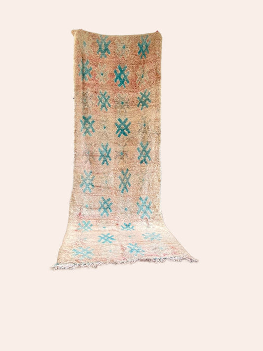 peach vintage Moroccan rug with blue symbols