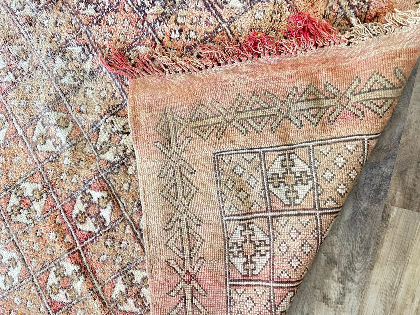 light orange/red vintage Moroccan rug with cream symbol pattern