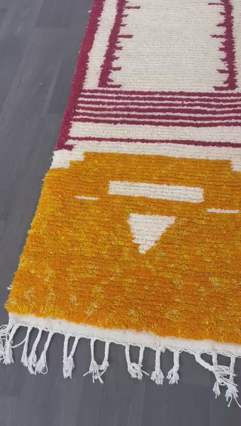 Video showing Colorful new Moroccan wool runner rug with geometric pattern on a dark wooden floor
