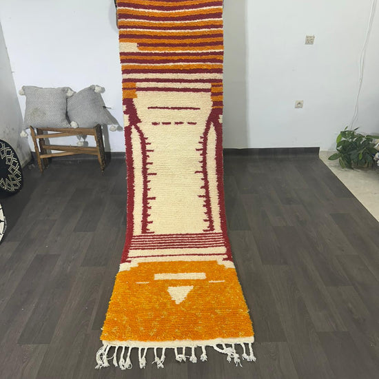 video of colourful striped wool rug on wooden background