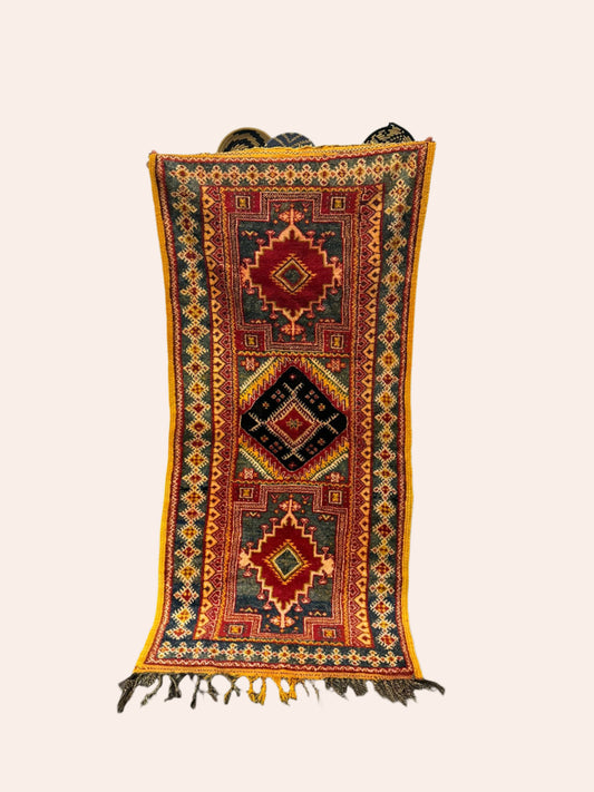 Vintage moroccan rug with geometric pattern on a wooden floor