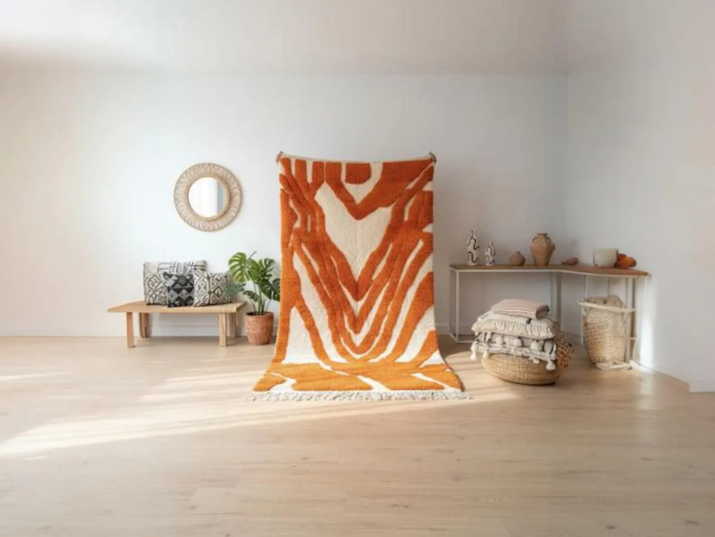 Orange and white patterned rug on a wooden floor with a white wall background
