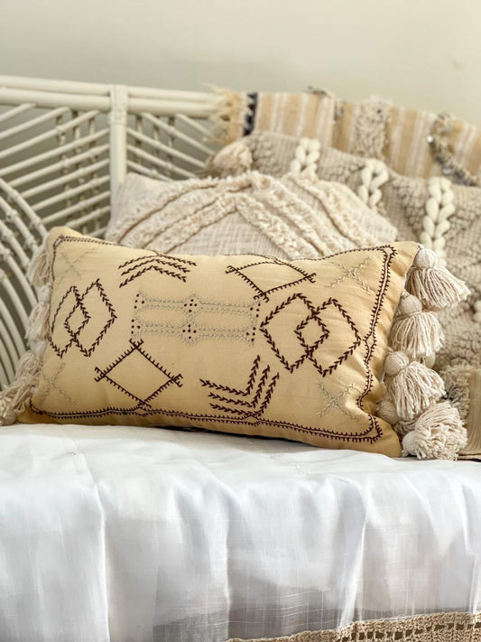 beige cotton cushion with embroidered detail